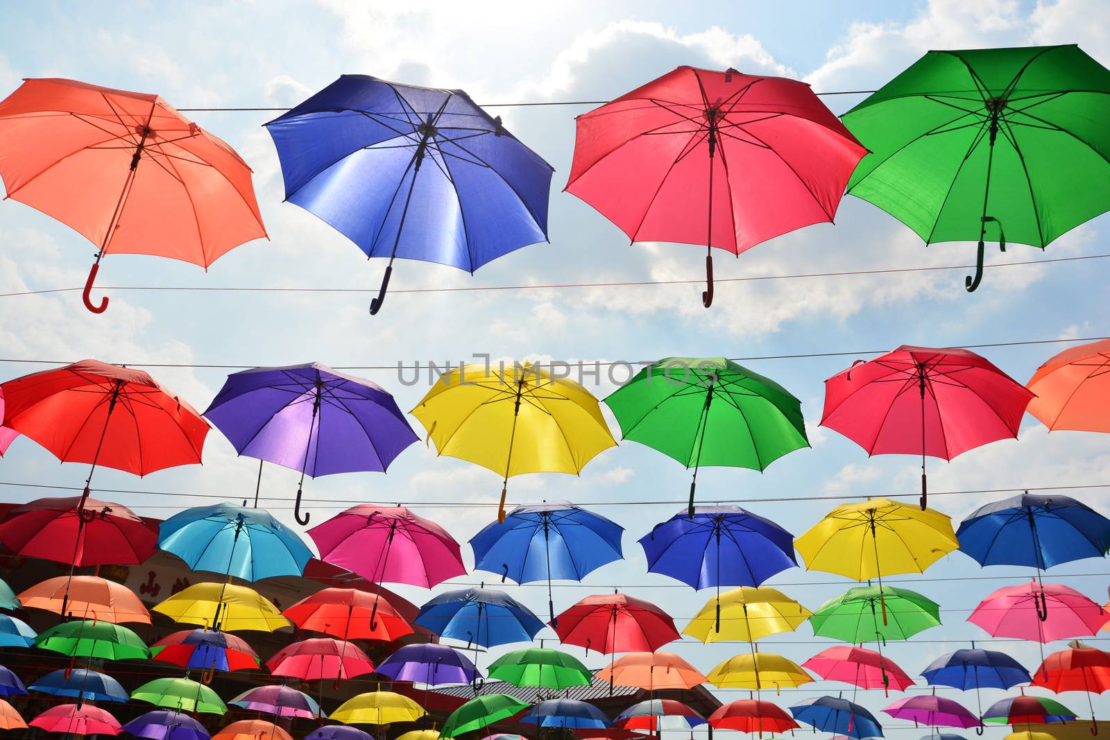 Colorful umbrellas background. Coloruful umbrellas urban street decoration.  by ideation90
