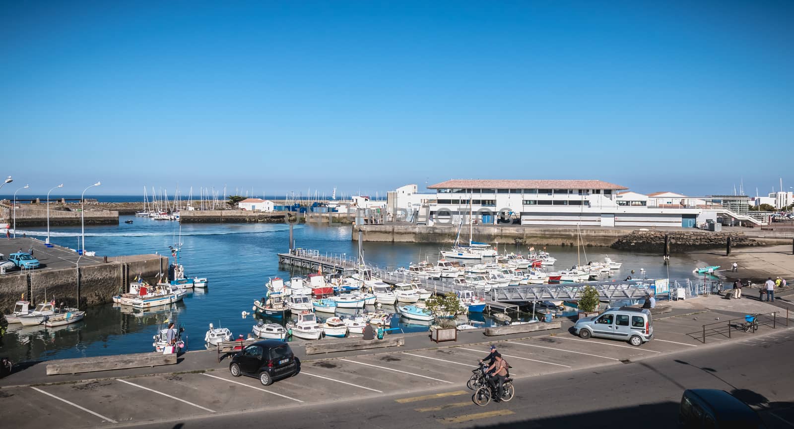 Port Joinville on the island of Yeu - September 17, 2018: view of the small port where maneuver fishing boats, tourism boats and sea shuttles going to the mainland on a summer day