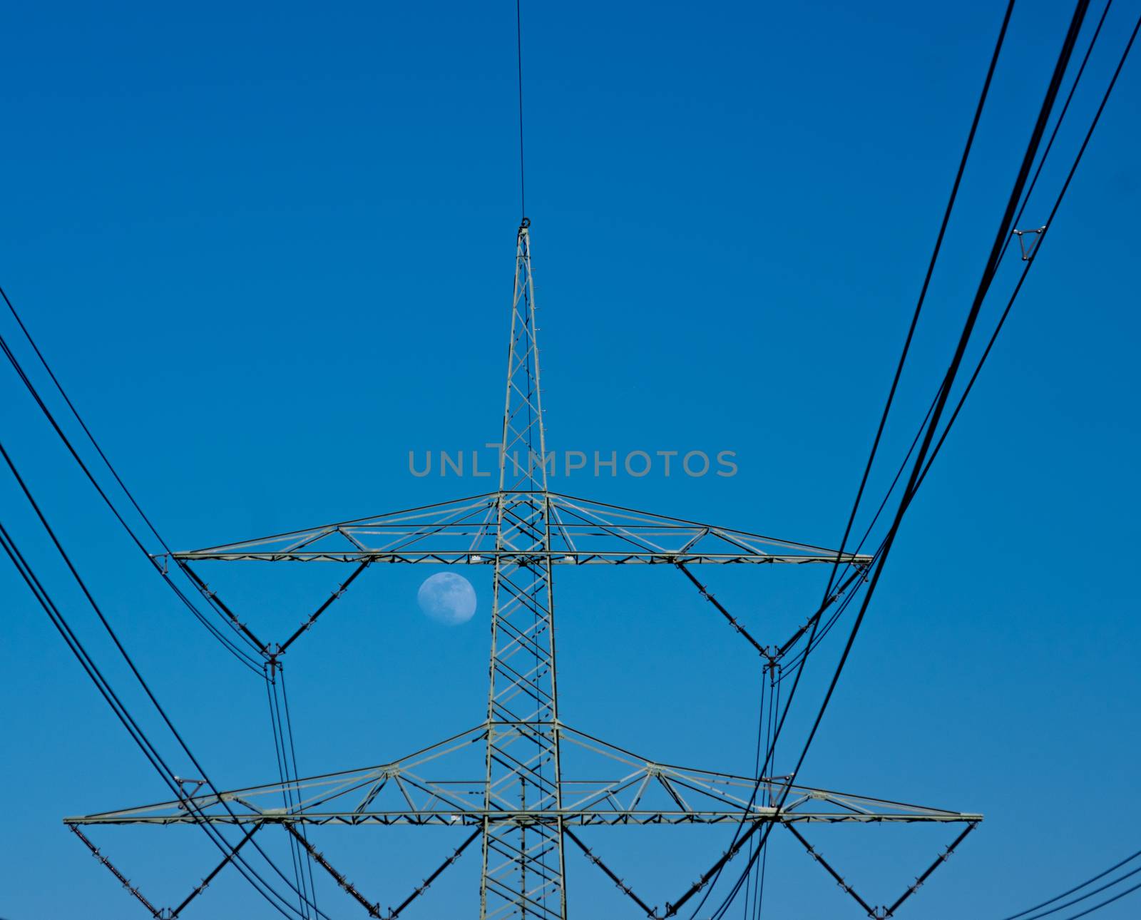 moon behind electricity pylon