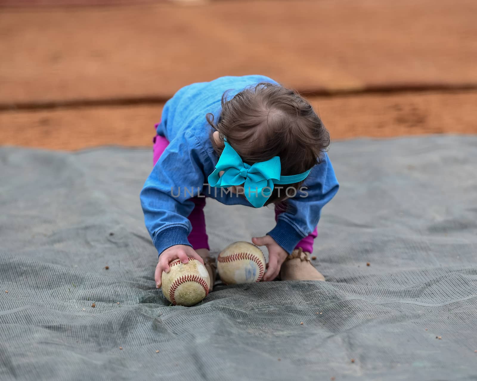 Cute Baby Girl Playing With Baseball Bat and Ball by Calomeni