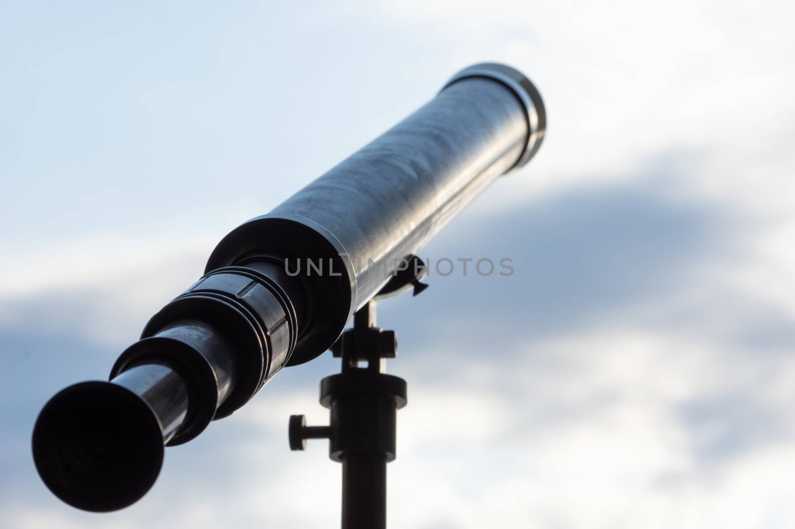 Detail of old nautical brass telescope looking into the sky