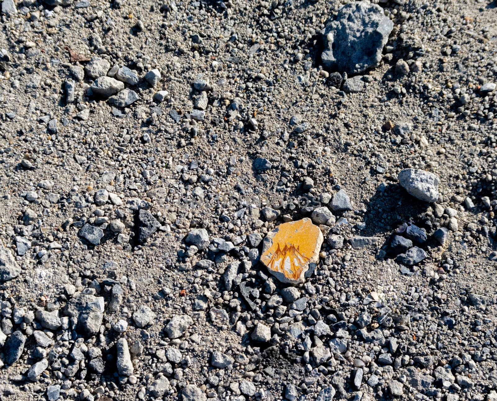 painted pottery shard on gravel road by MarcoWarm