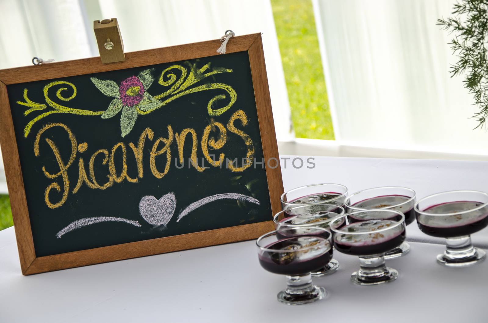 Mazamorra purple, sweet typical of Peru and next to the box says Picarones another sweet typical of Peru