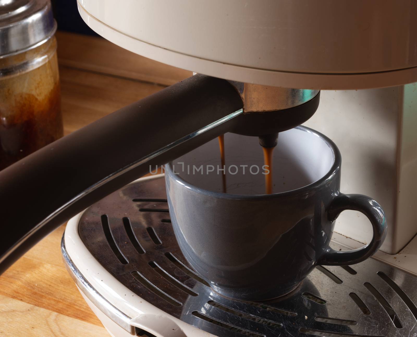 preparing coffee with a coffee maker filling a cup