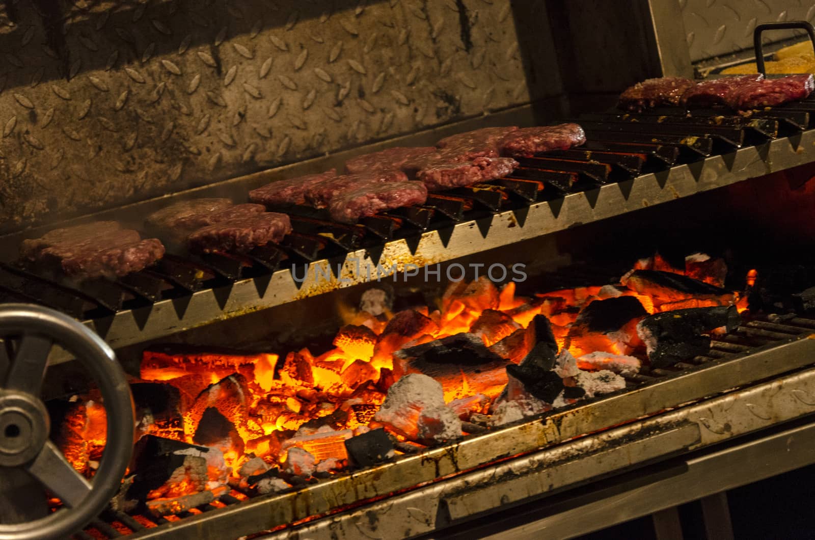 Cooking meat on a large charcoal grill