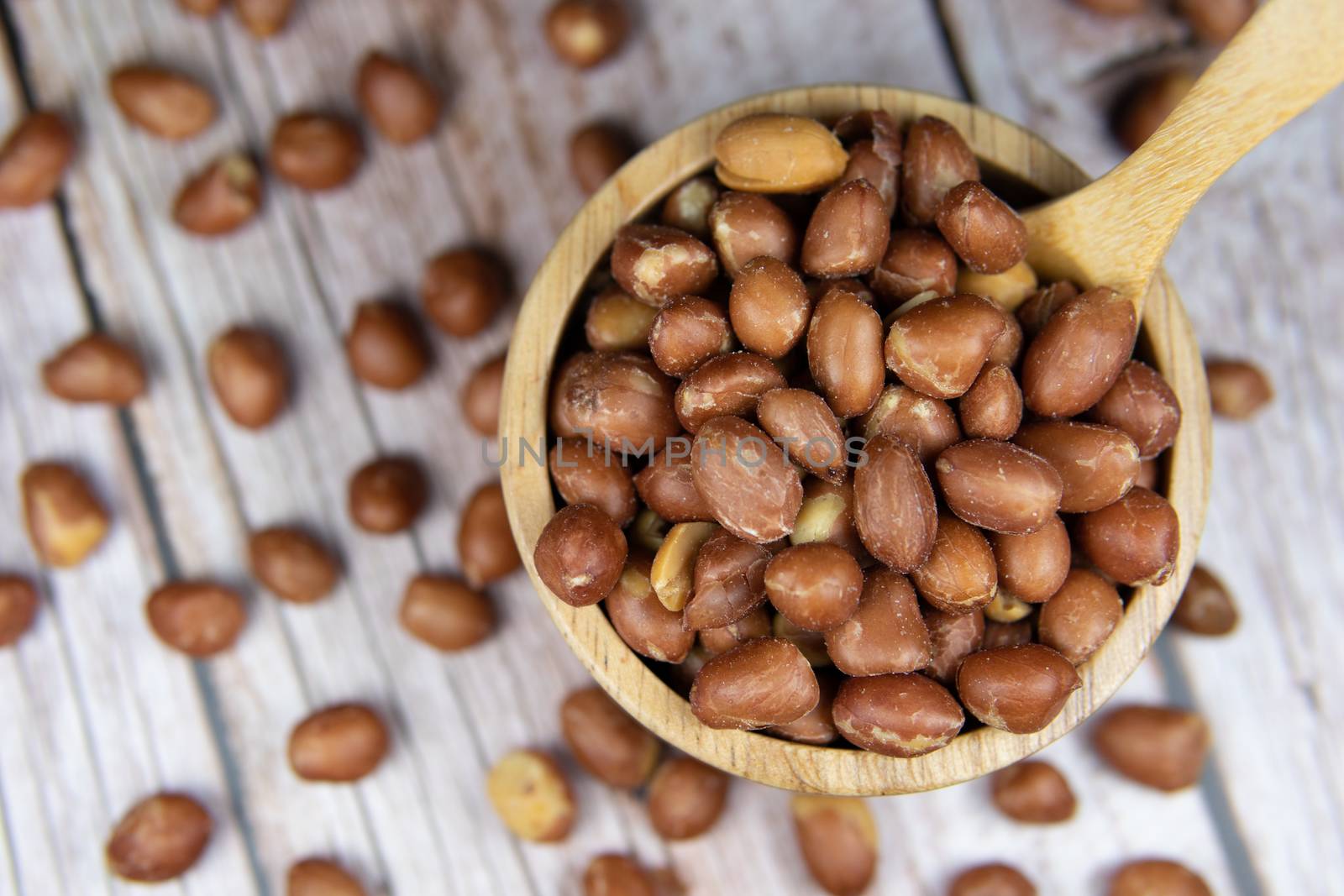 Peanuts peeled in a wooden bowl by Jarukit