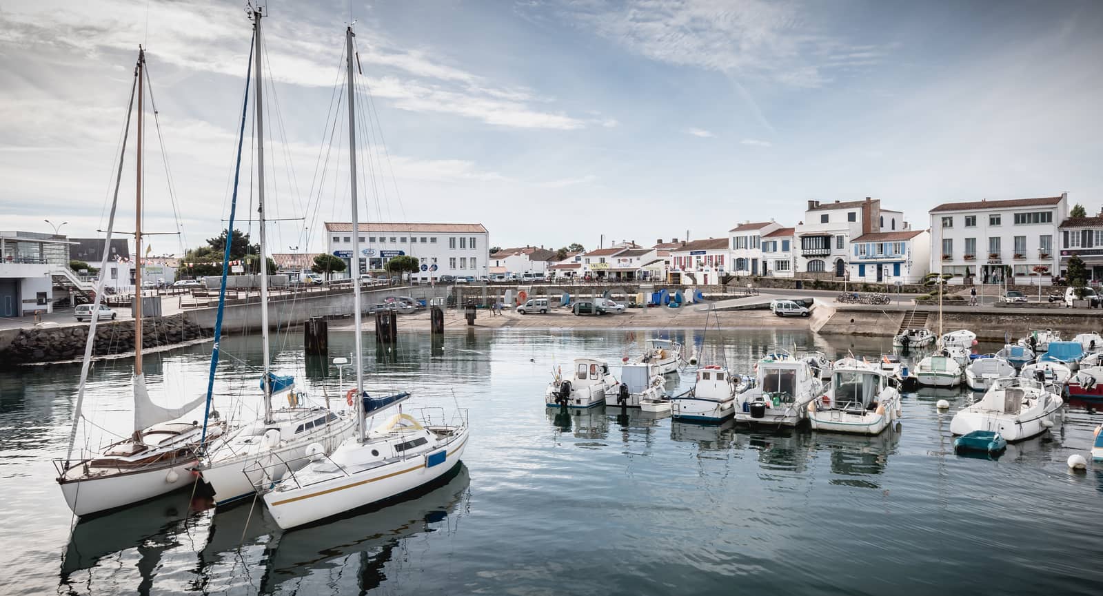 Port Joinville on the island of Yeu - September 17, 2018: view of the small port where maneuver fishing boats, tourism boats and sea shuttles going to the mainland on a summer day