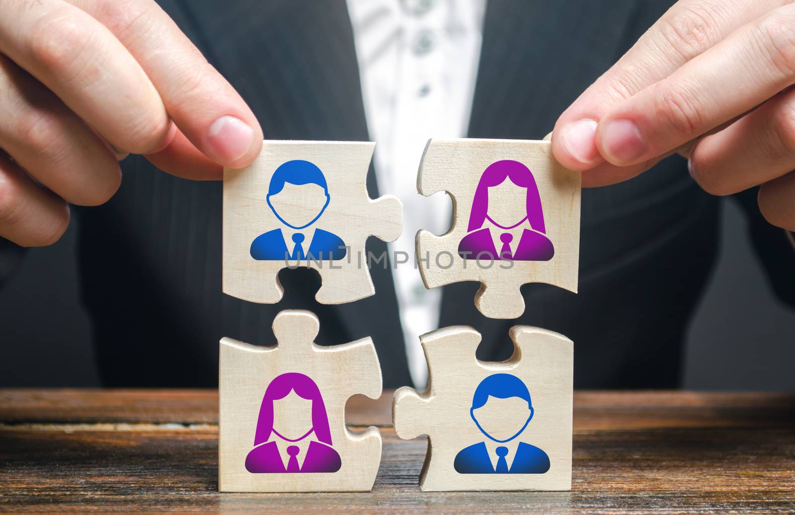 Businessman assembles a team in the form of a set of puzzles. Search, hiring and recruitment staff. Creating an efficient and productive business unit. Leadership and teamwork. Managerial qualities. by iLixe48