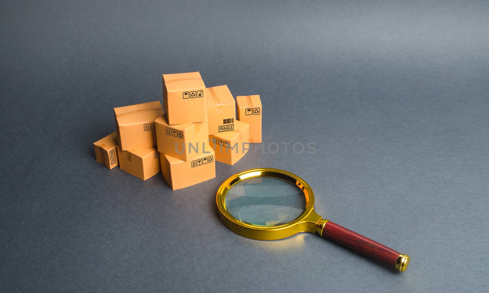 A pile of boxes and a magnifying glass. Concept search for goods and services. Tracking parcels via the Internet. Quality control of goods. Search for customers for sale, sales and retail. by iLixe48