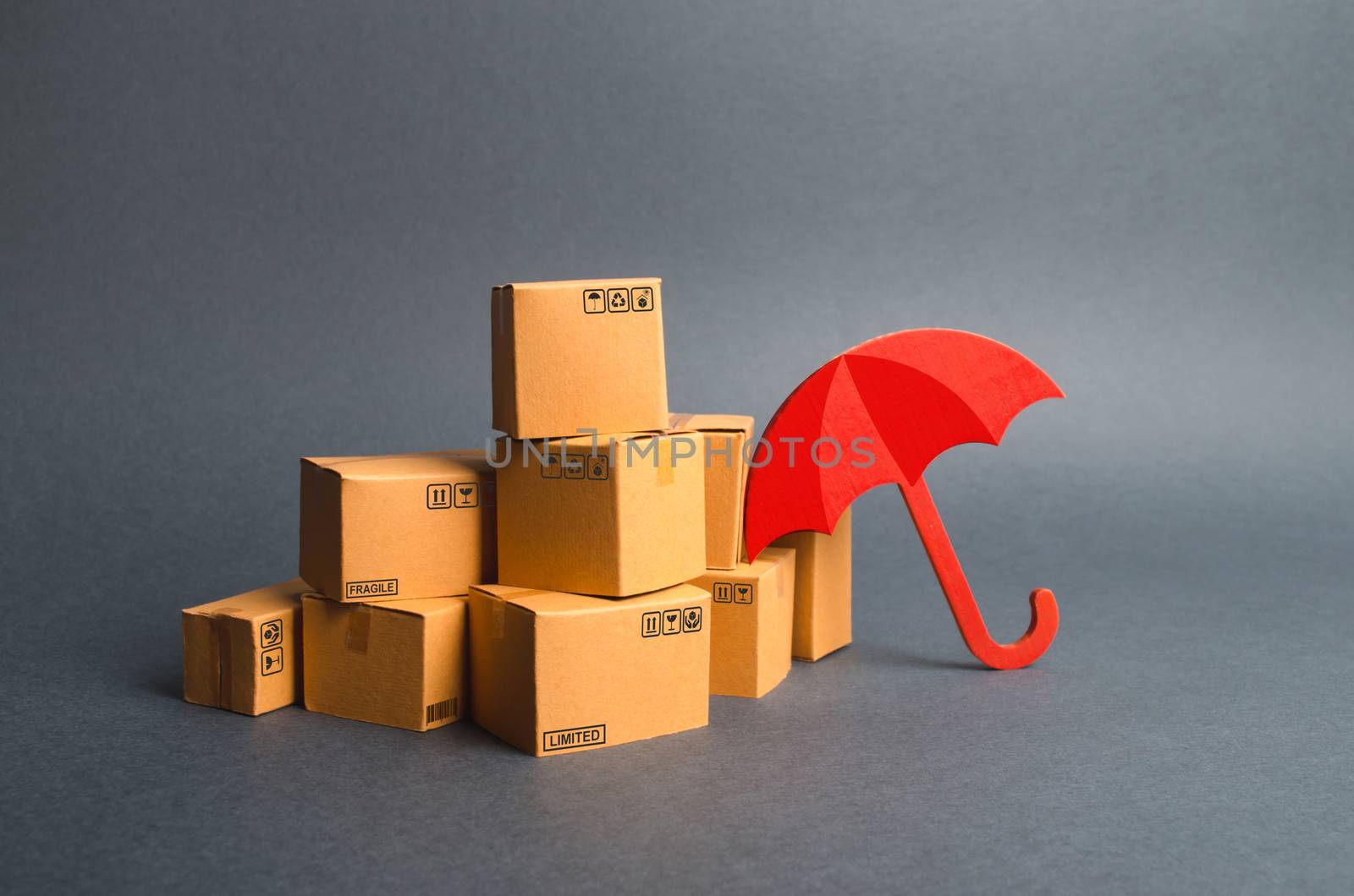 A bunch of cardboard boxes and umbrella. concept of insurance purchases. Providing warranty on purchased products. Consumer rights Protection. Support of the national manufacturer by government