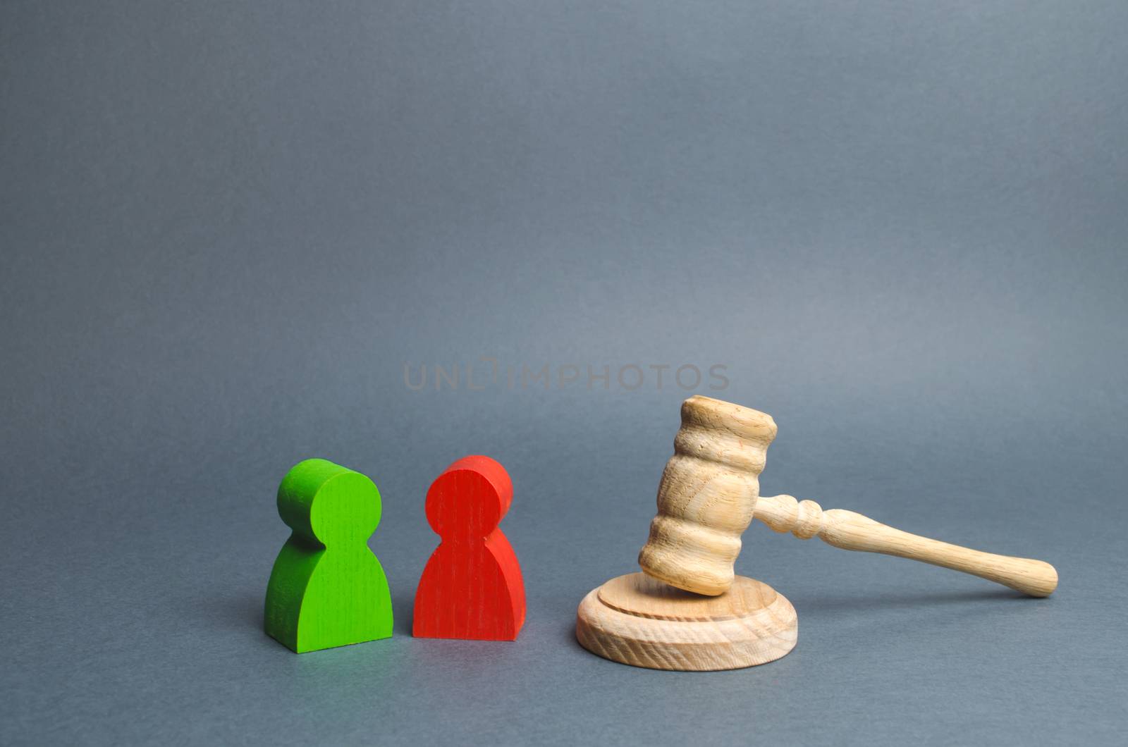 Two figures of people opponents stand near the judge's gavel. Conflict resolution in court, claimant and respondent. Court case, resolution and disputes settling disputes. The judicial system.