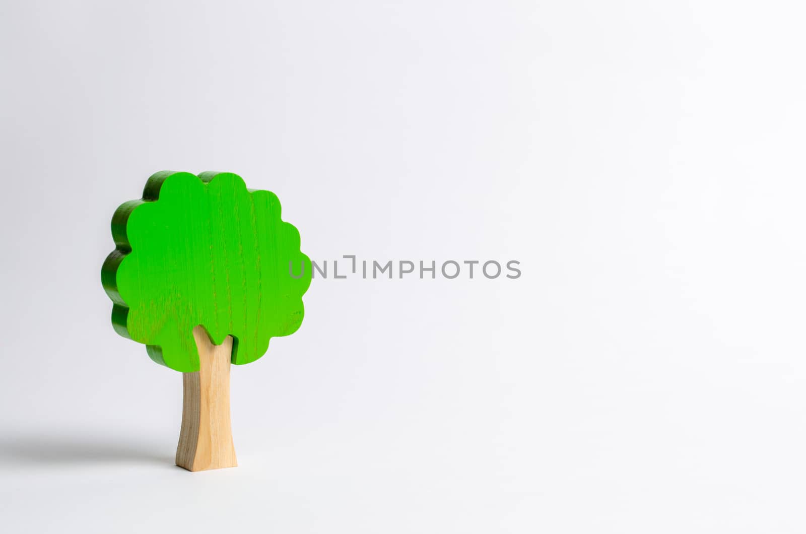 Toy wooden tree on a white background. Minimalism and the concept of environmental conservation. lungs of the planet. Family tree, a symbol of strength and wisdom. Illegal deforestation. by iLixe48
