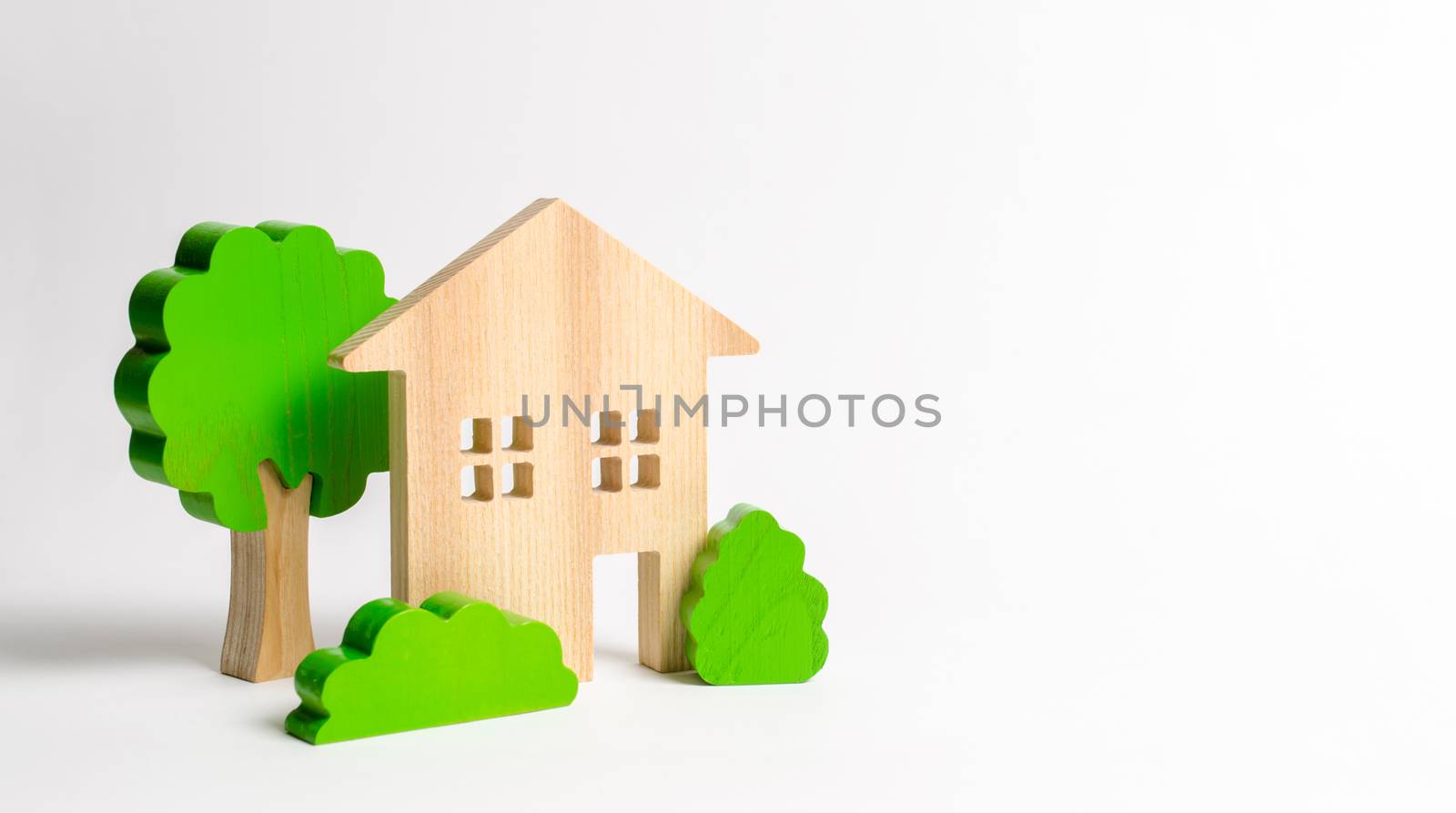 Large two-story house surrounded by bushes and trees. Urbanism and urban landscaping. Acquisition of affordable housing in a mortgage. Accommodation for young families. Apartments for rent