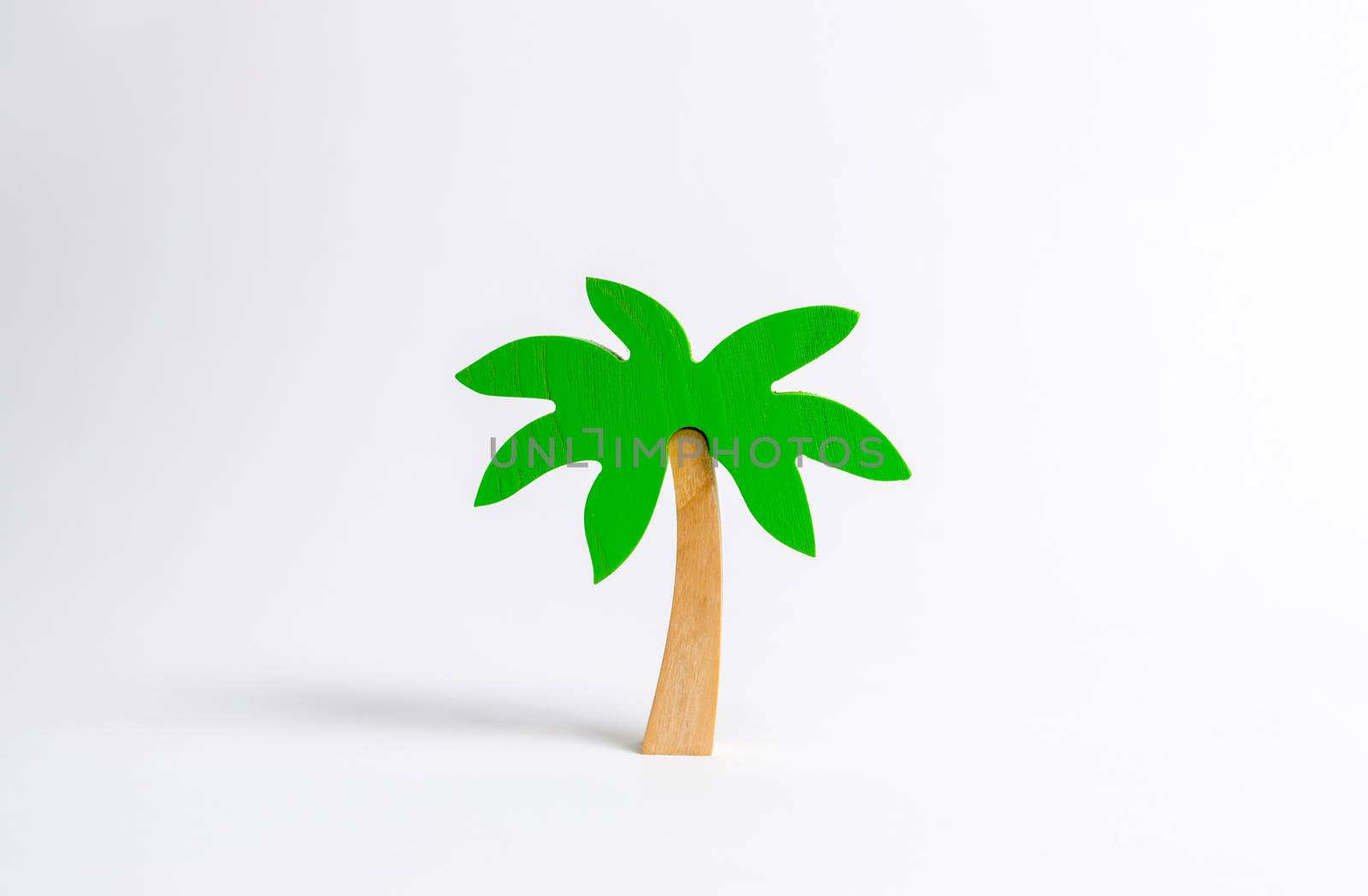 Wooden palm tree on a white background. Tours and cruises to warm countries. The development of tourism. Tropical island. Conceptual leisure and vacation, entertainment and relaxation. by iLixe48