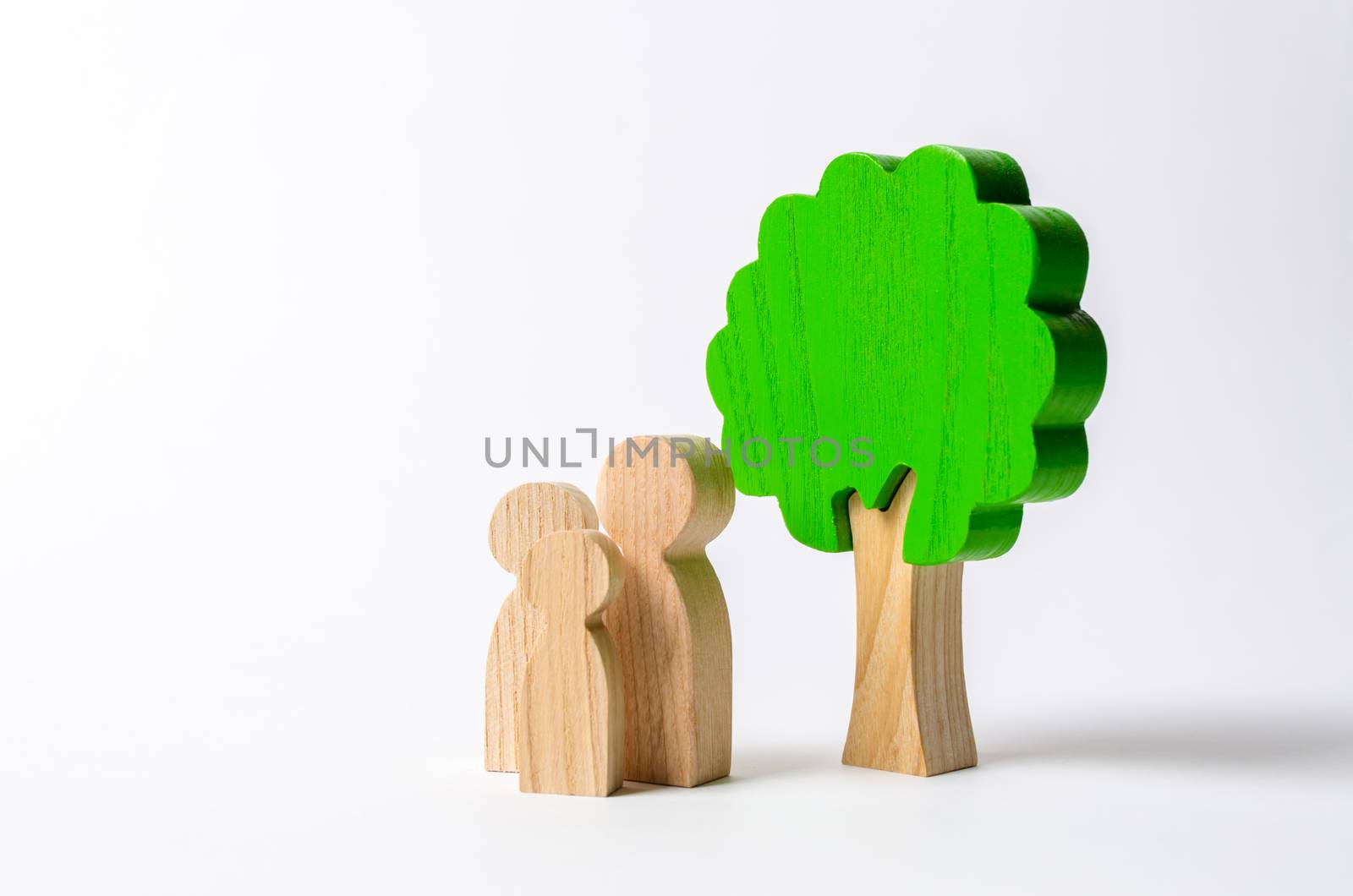 Family figures are standing near the tree. Pastime with family, kinship and parenting. Instilling good qualities and values in a healthy society. The concept of happiness and unity with nature. Health by iLixe48