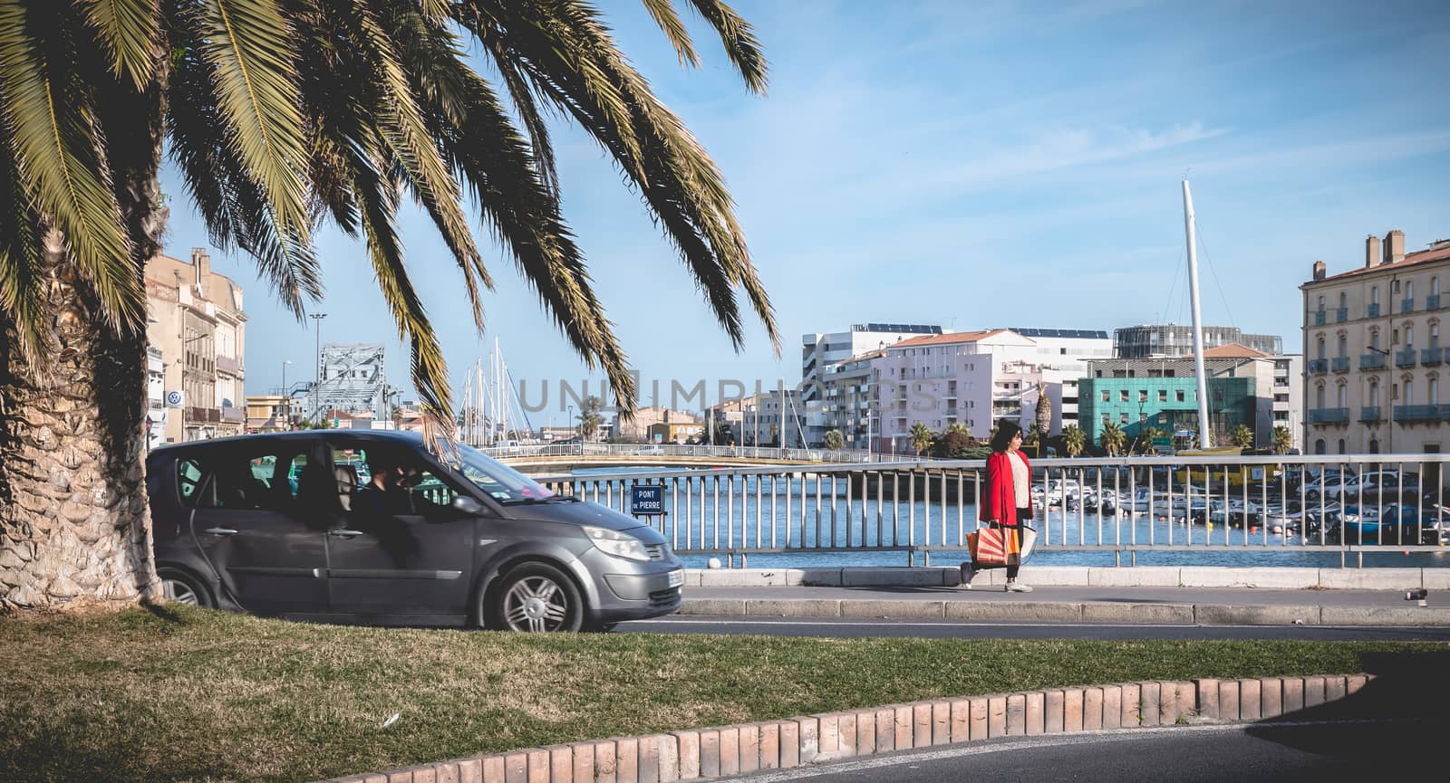 Sete, France - January 4, 2019: Street atmosphere on the stone bridge near the marina on a winter day