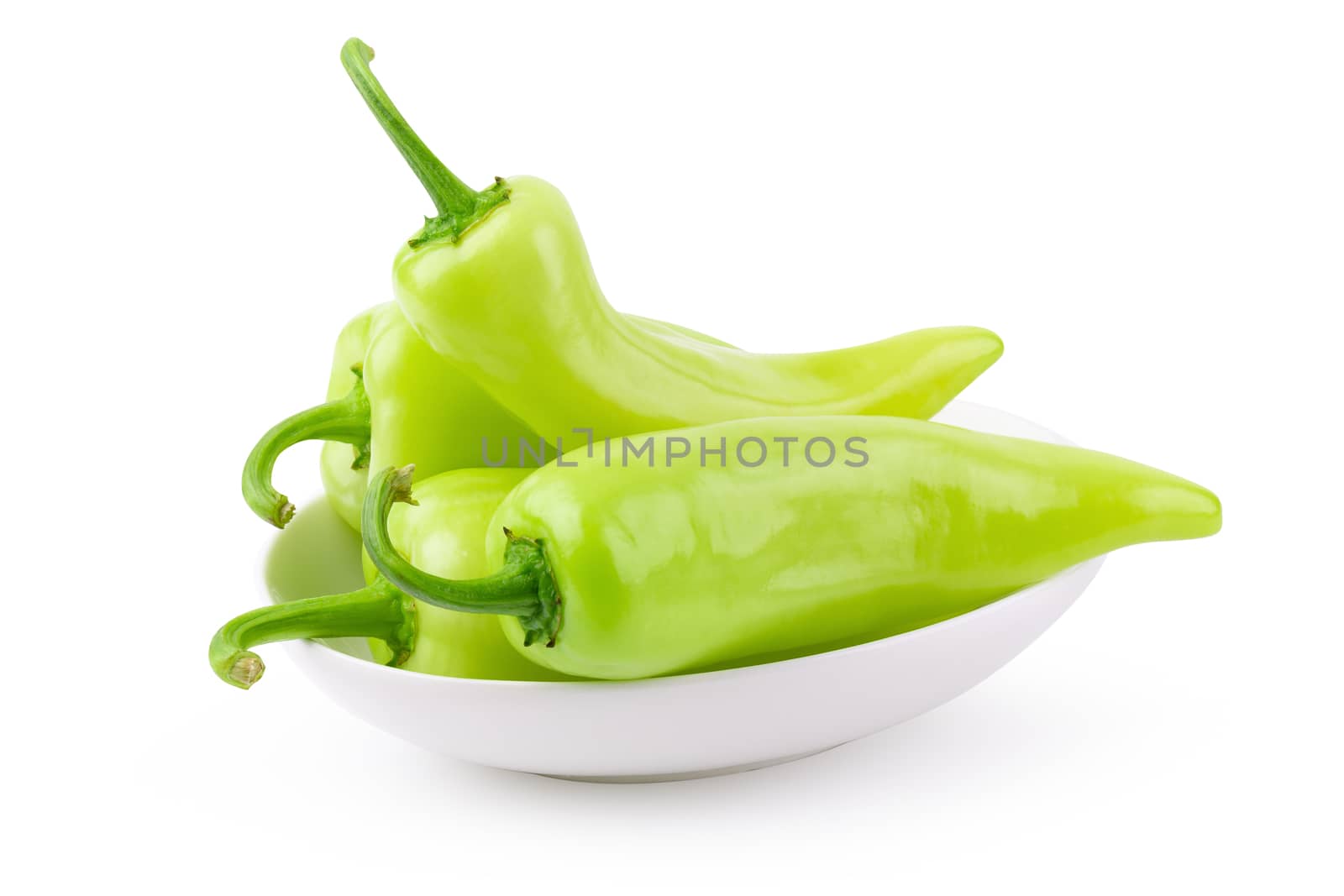 Green hot chili peppers in white ceramic bowl isolated on white background.