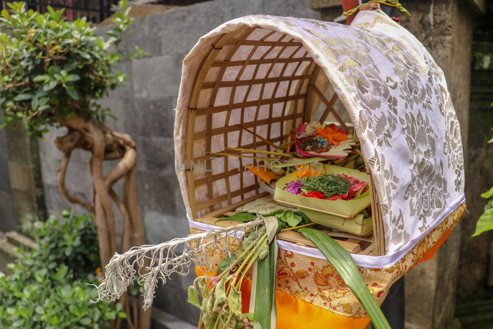 Altar woven from bamboo wicker, covered with white cloth with gold pattern. Offerings to the Gods stored inside a Hindu altar, Bali, Indonesia. Culture and religion of Balinese believers.