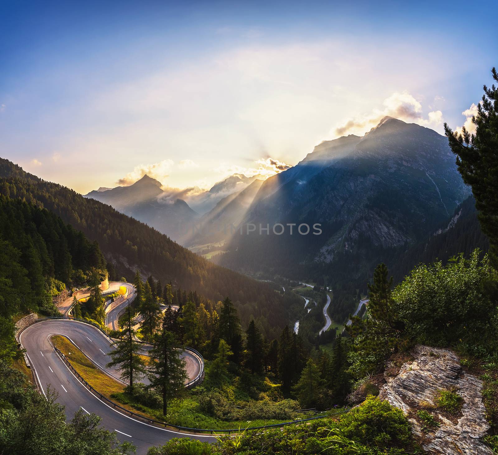 Aerial view of Maloja Pass road in Switzerland at sunset. This Swiss Alps mountain road is located in dense forests of the canton Graubunden. Hdr processed panorama.