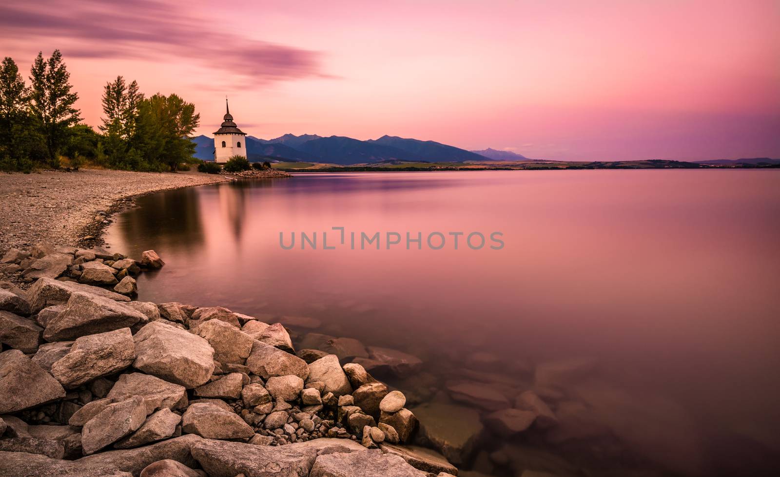 Sunset over a little church in Liptov, Slovakia by nickfox