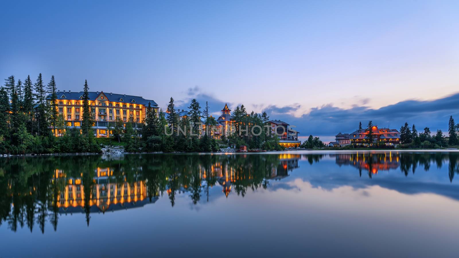 Sunset over glacial mountain lake Strbske Pleso in National Park High Tatra, Slovakia. Long exposure.