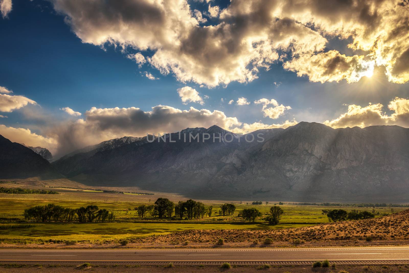 Play of lights and clouds before sunset above Sierra Nevada, California by nickfox