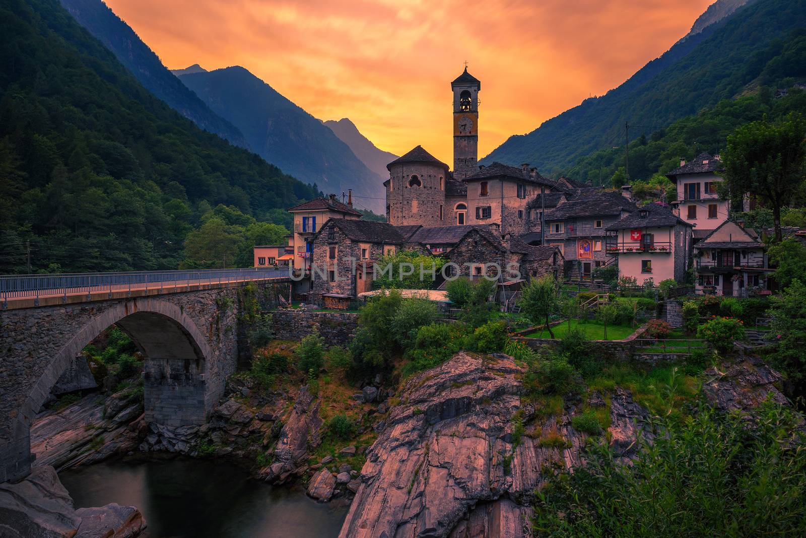 Colorful sunset above the Lavertezzo village, Papal minor Basilica and the Verzasca river in the Swiss Alps, Canton Tessin, Switzerland