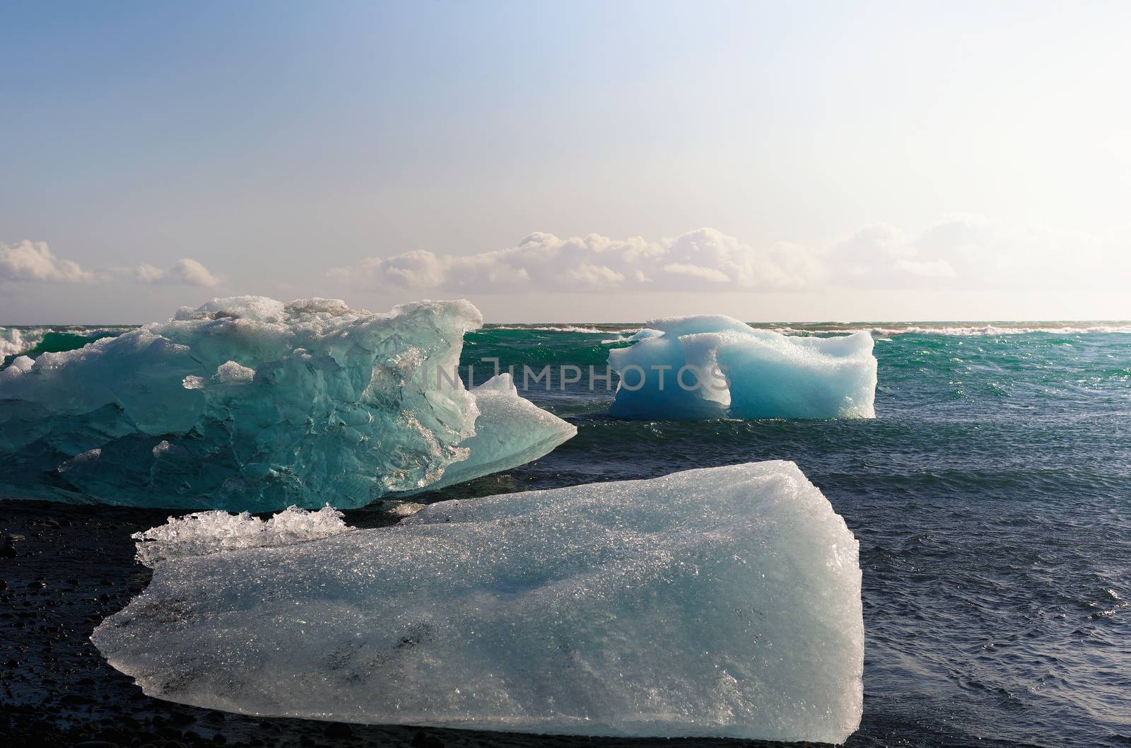 Icebergs lying on the Diamond Beach in Jokulsarlon Glacier Lagoon, Iceland by nickfox