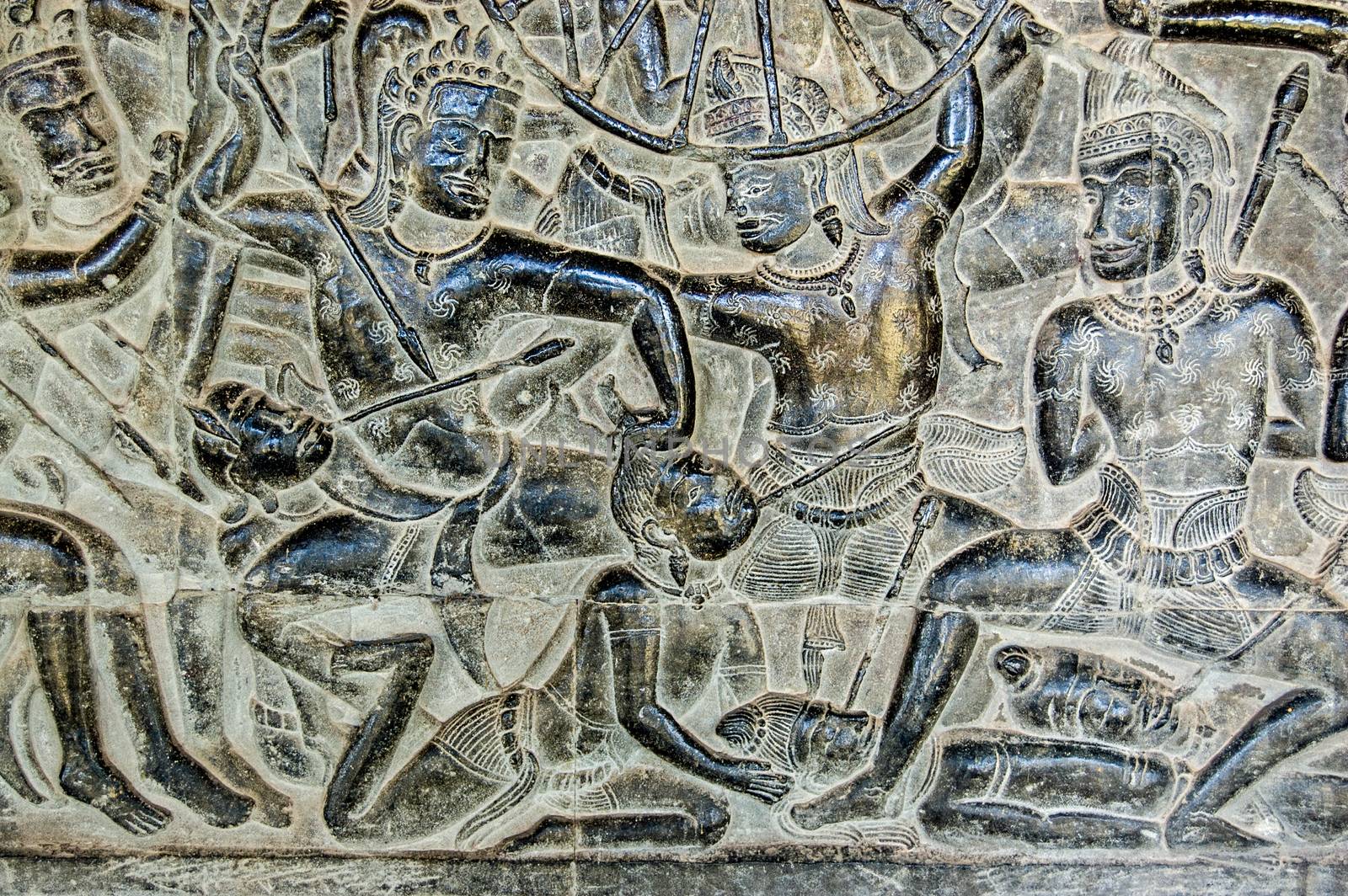 An ancient Khmer carving of the Battle of Kurukshetra showing a man being killed as described in the Mahabharata. Bas Relief, Angkor Wat Temple, Siem Reap, Cambodia.