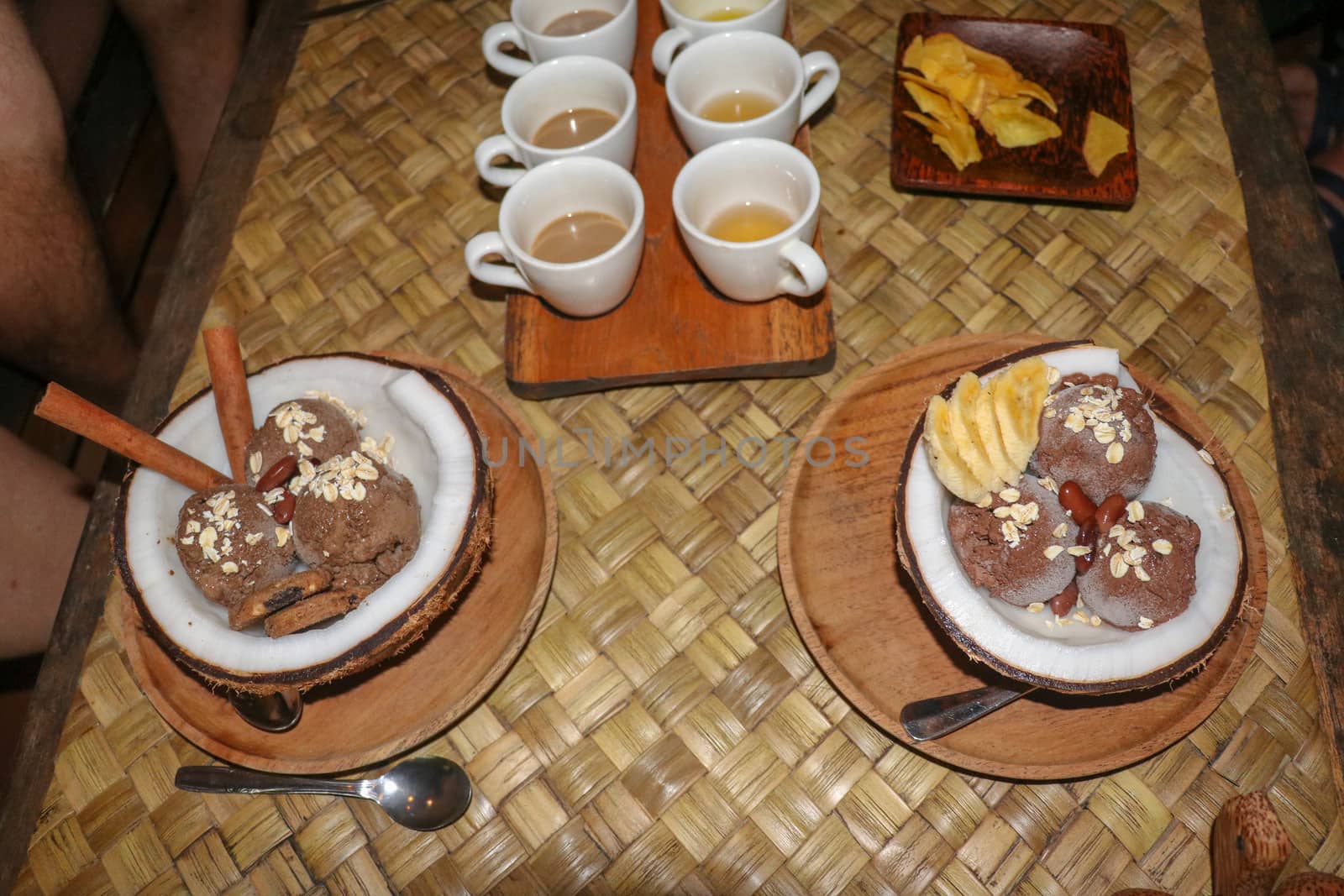 Chocolate ice cream served in fresh coconut with flesh. Sweet dessert with cocoa cookies, , banana slices and pieces of cinnamon. Delicious delicious dessert suitable as refreshment on summerer days.
