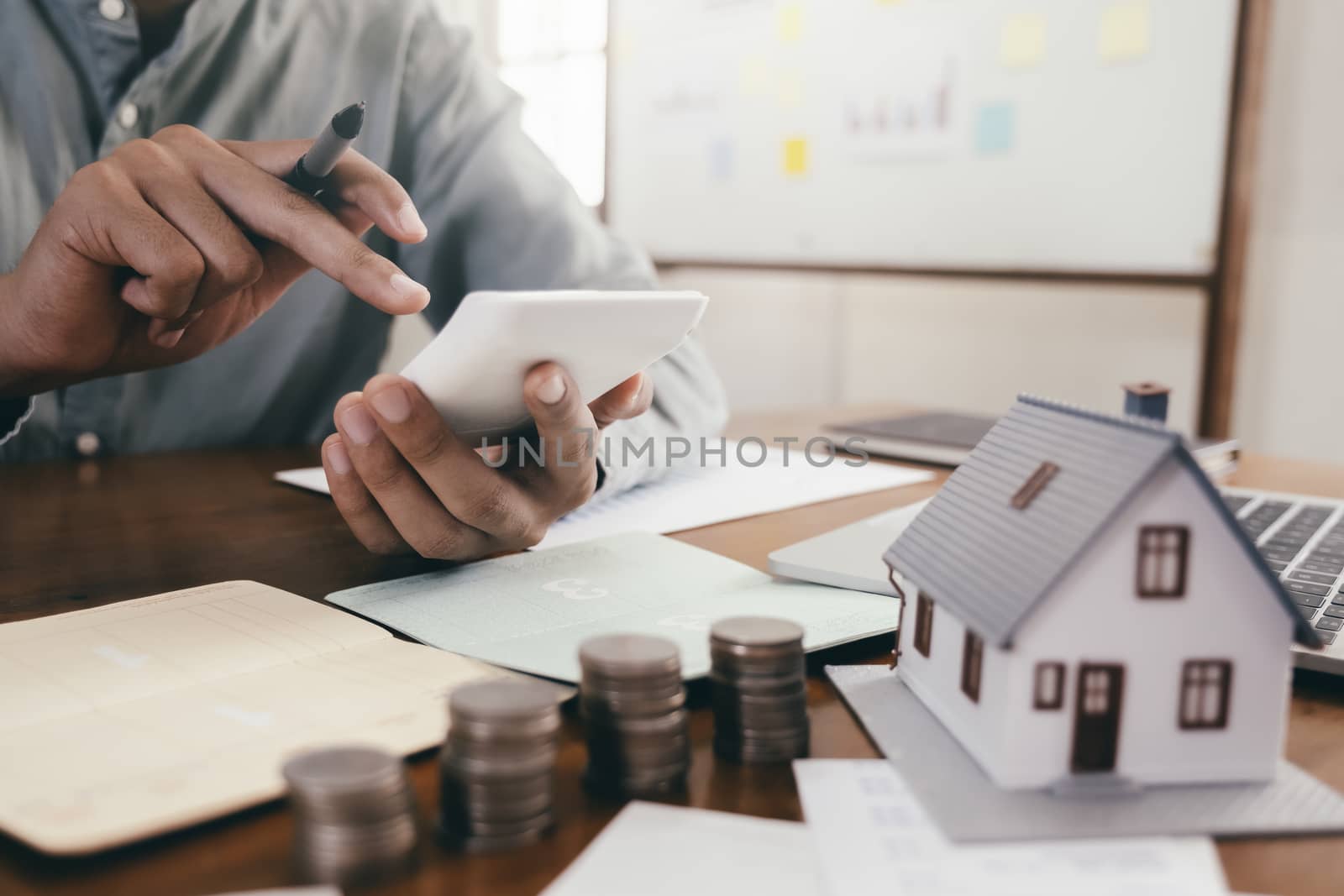 Close up male hand calculate the money for investment in property and mortgage. Finance and saving money for investment.