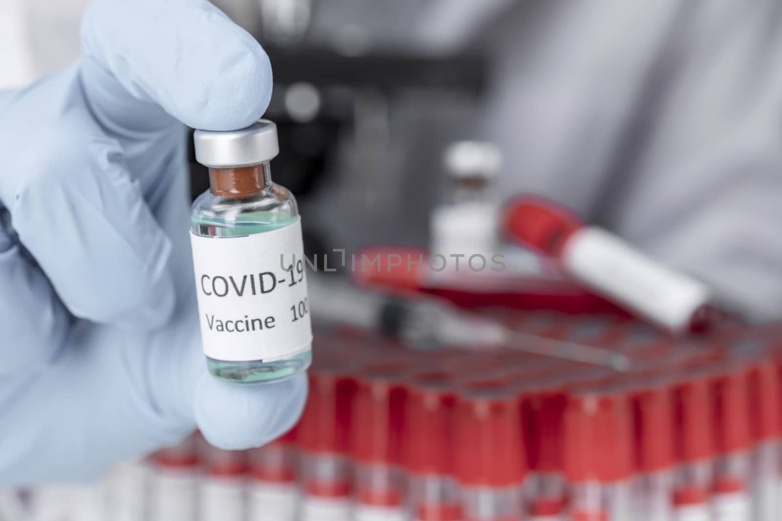 Hand holds Coronavirus Covid-19 Vaccine glass bottle. Healthcare by Aedka_Stodio