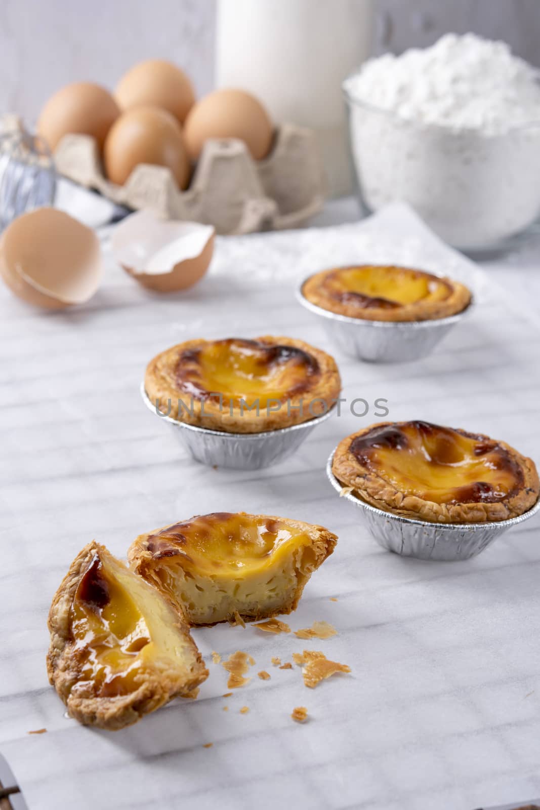 Egg tart, traditional Portuguese dessert, pasteis de Nata Portuguese Custard Tarts food on a Cooling Rack. Typical custard pies.