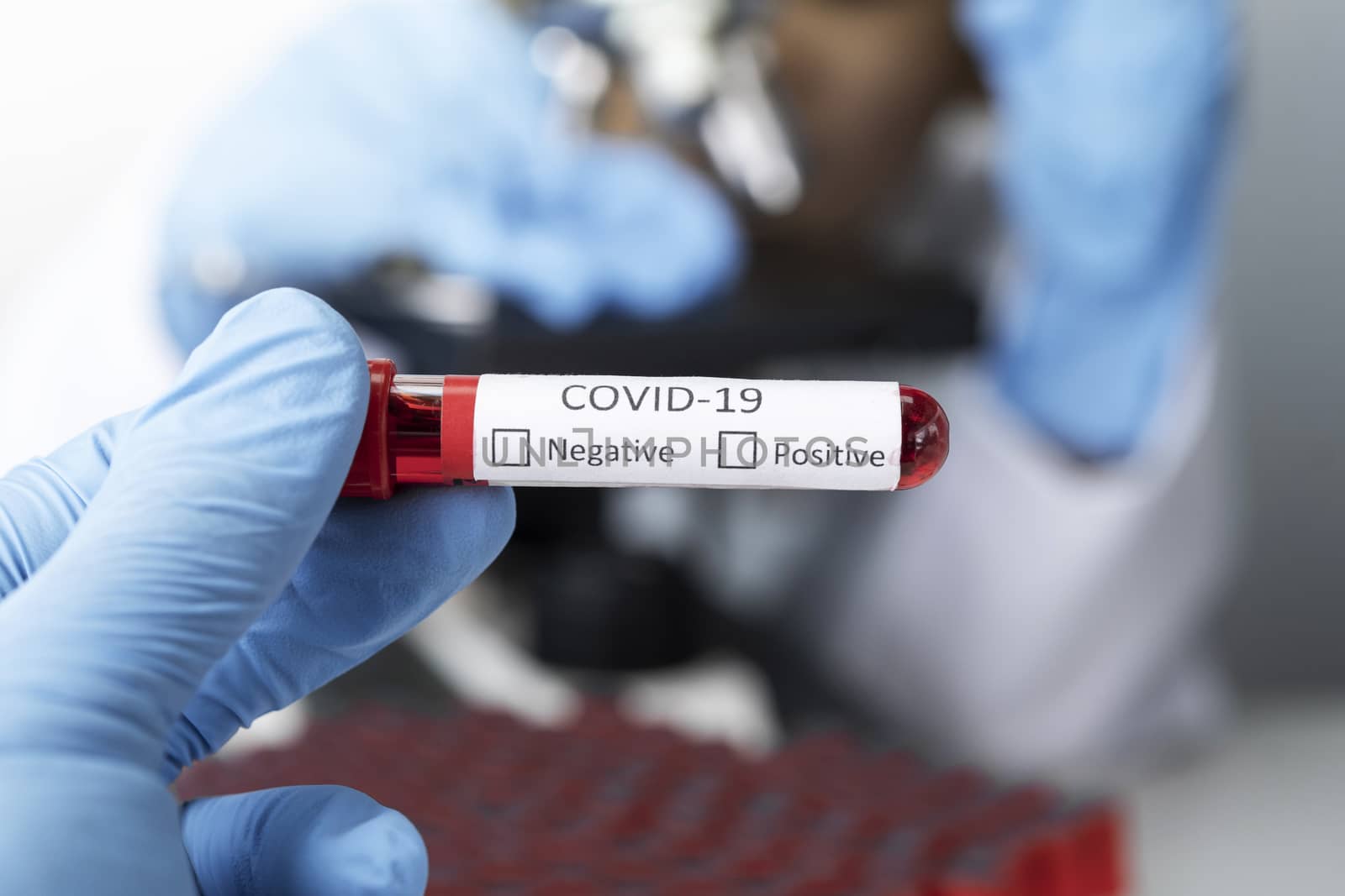 Cropped view of scientist in latex glove holding test tube with blood sample, Test tube with blood sample for COVID-19 test, novel coronavirus 2019.