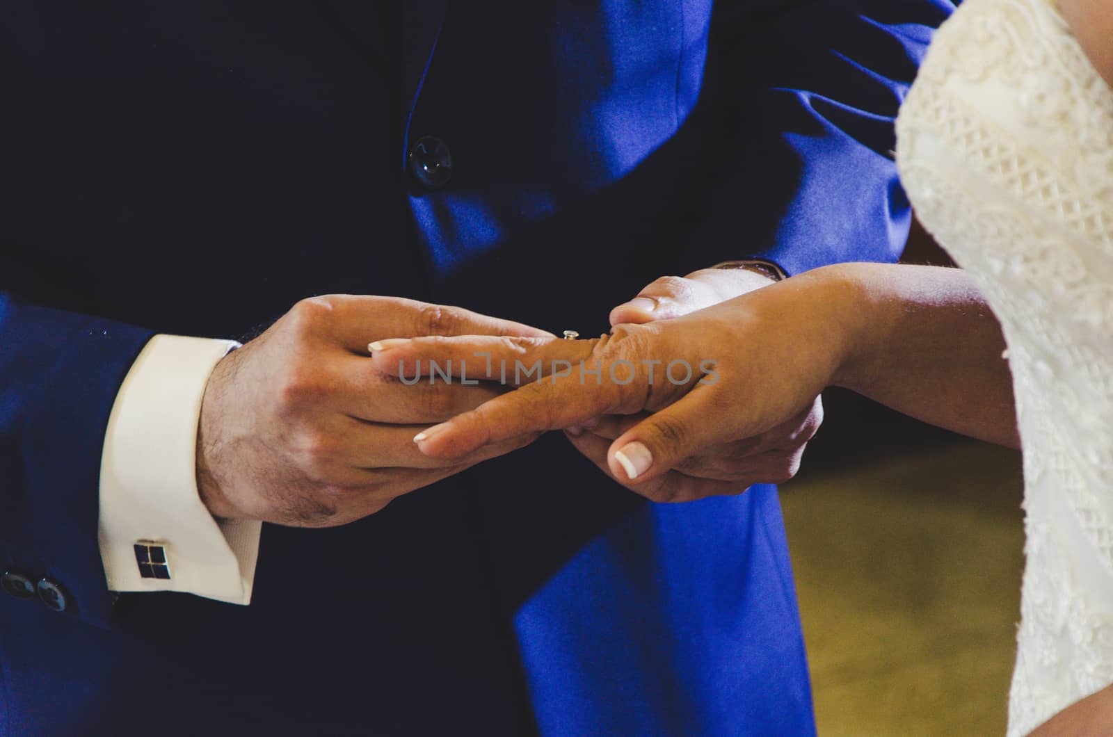 Groom placing the ring to his girlfriend