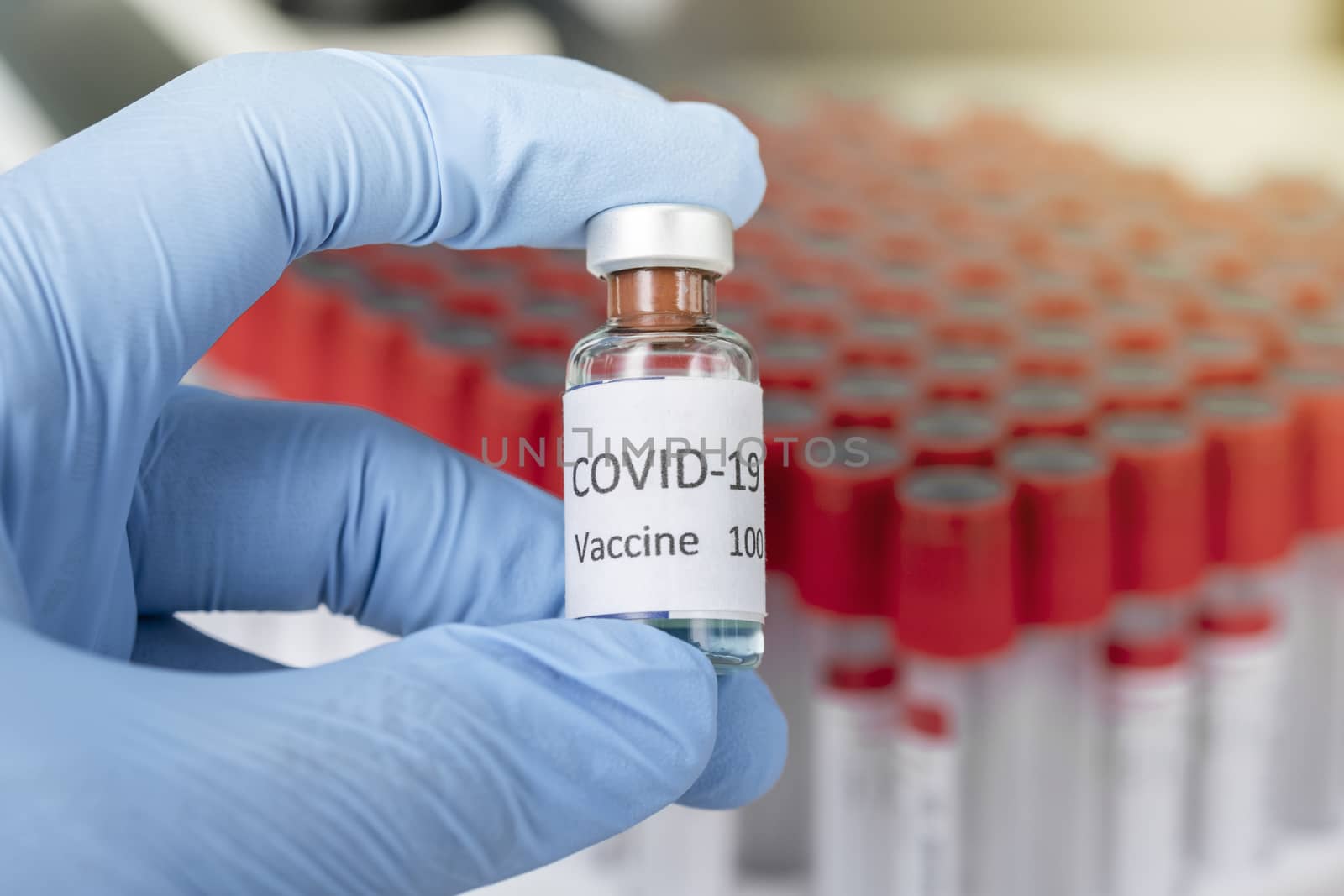 Hand holds Coronavirus Covid-19 Vaccine glass bottle. Healthcare And Medical concept.