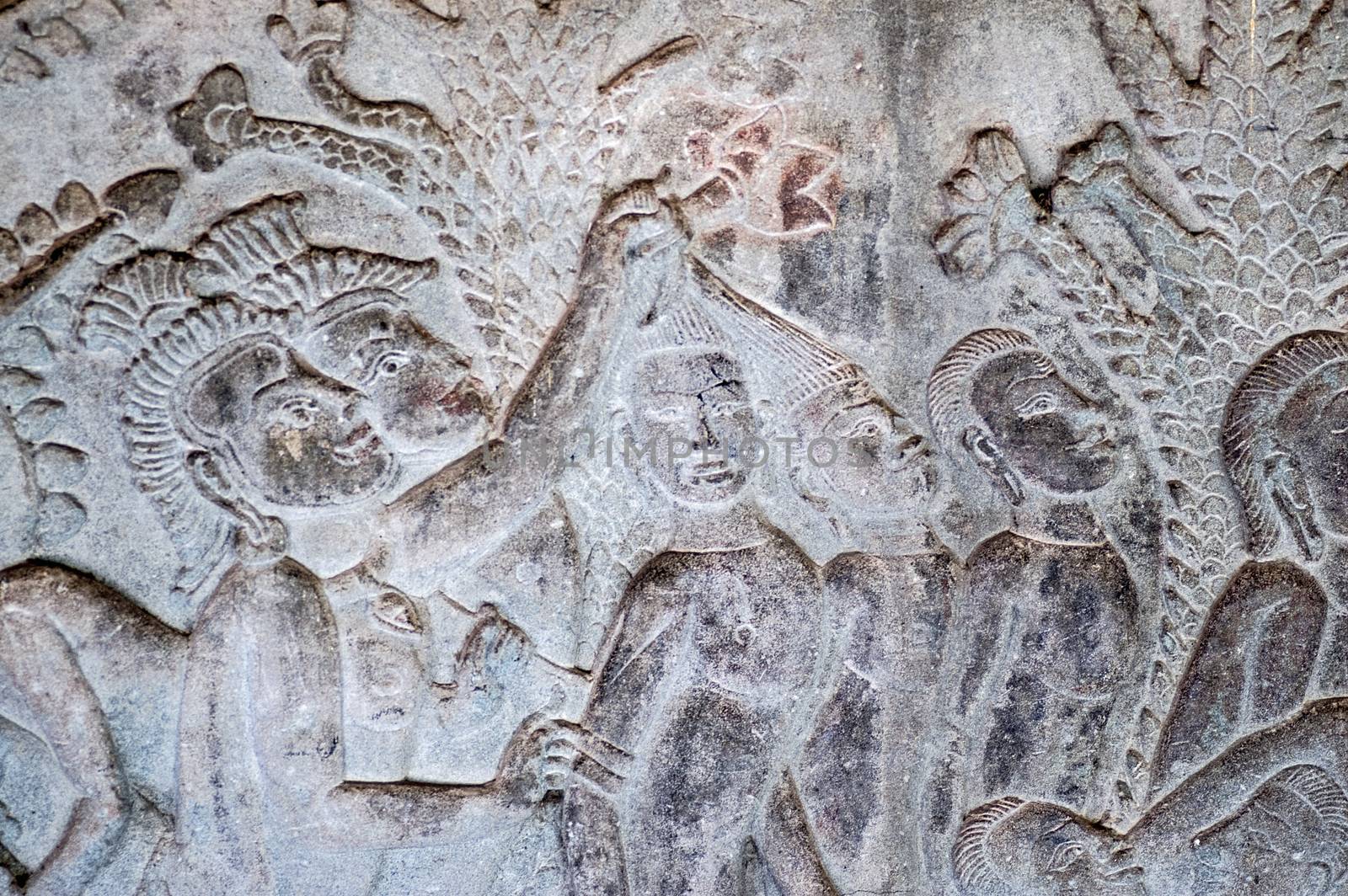 A bas relief carving showing sinners hair being pulled by demons in one of the 32 hells in the Hindu religion. South gallery, east section, Angkor Wat Temple, Siem Reap, Cambodia.