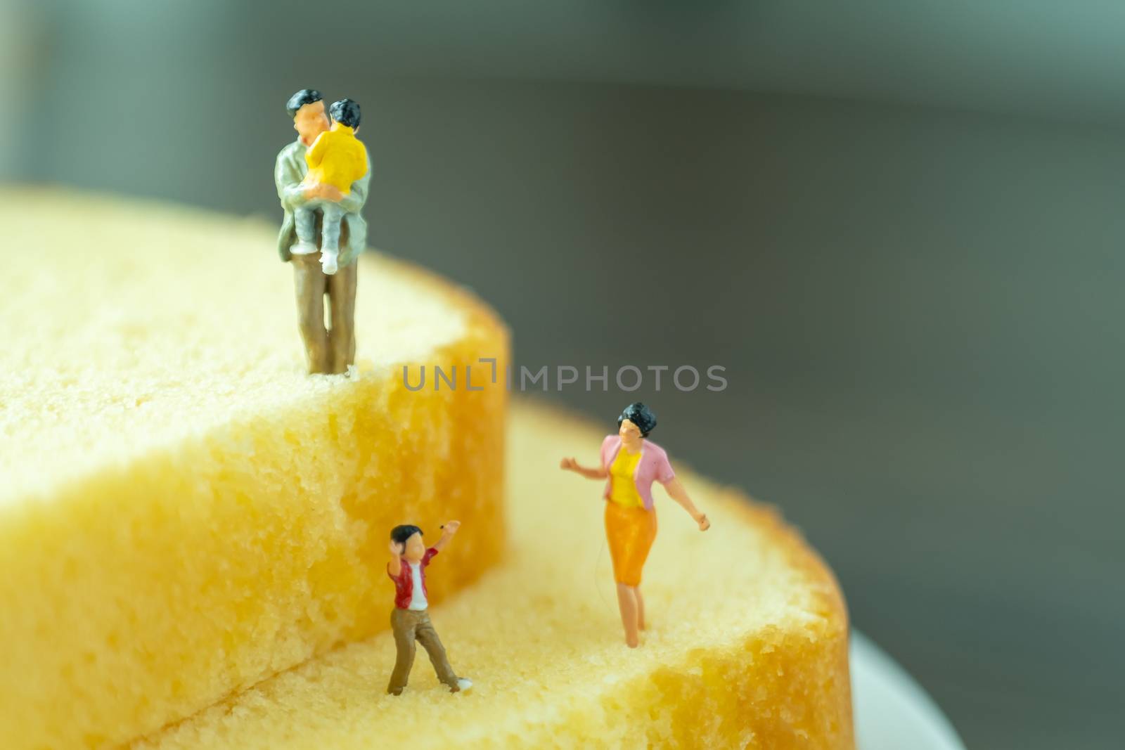 miniature of family model on butter cake by Toefotostock
