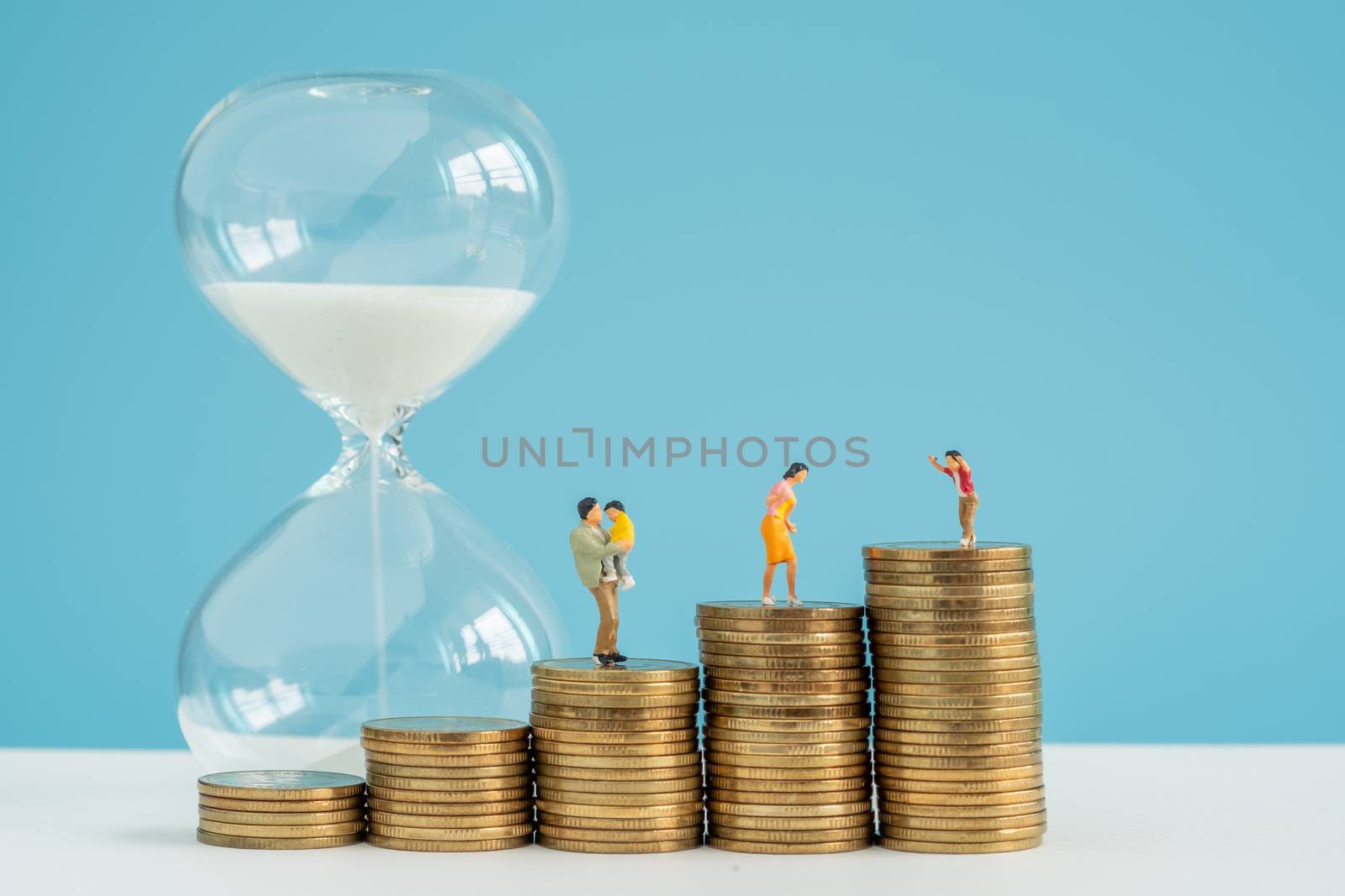 hourglass and stack coin with savings substantial money inside f by Toefotostock