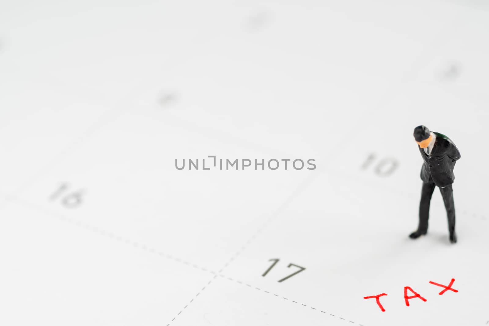miniture business model on calender.Tax management concepts. by Toefotostock