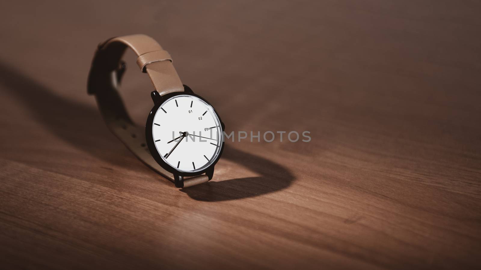 wristwatch on a wooden table with copy space by marynkin