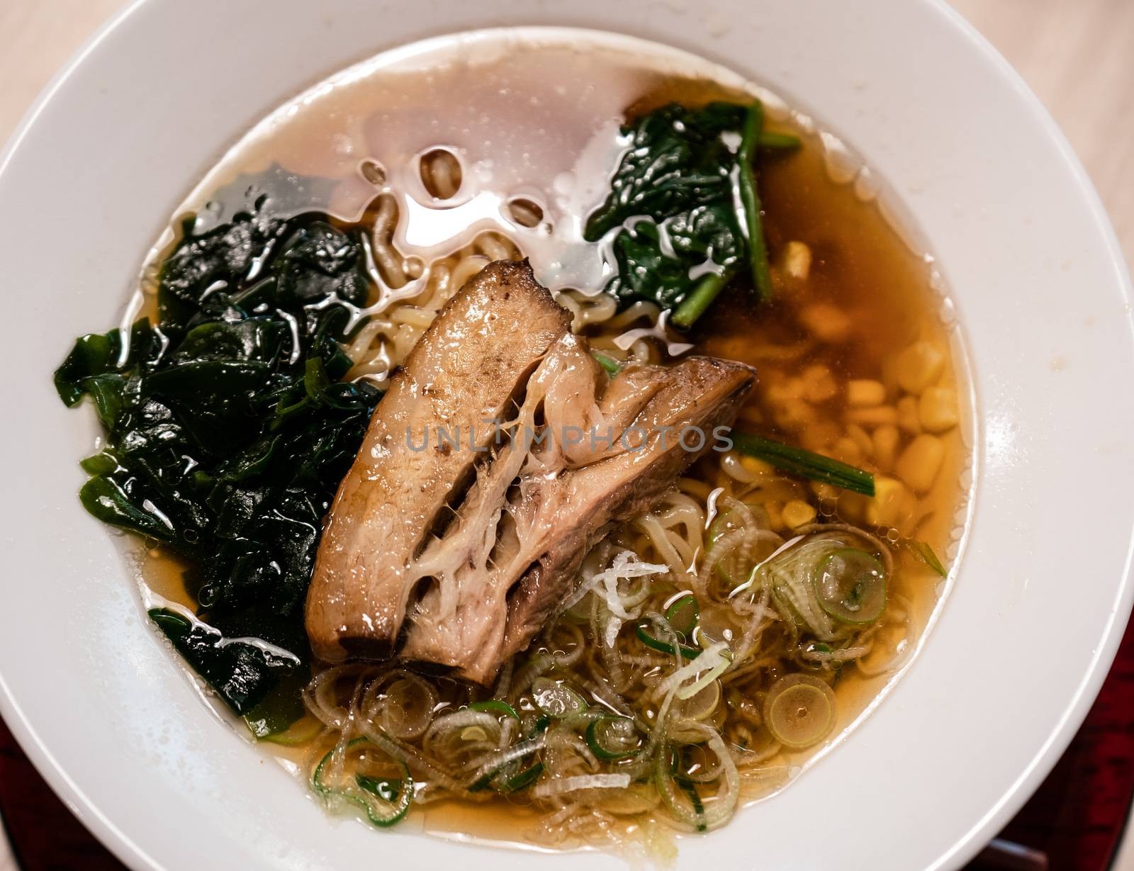 Delicious Japanese ramen noodles with pork, and seaweed on bowl.