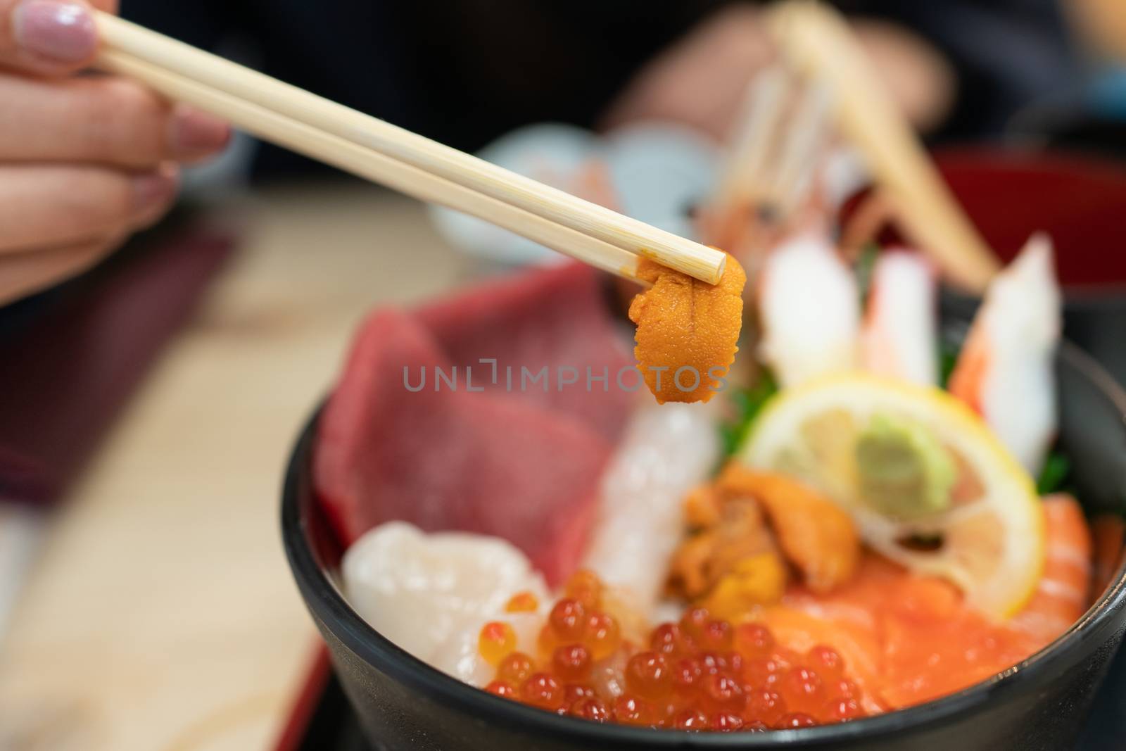 Kaisen Don (Sashimi seafood Rice Bowl) served in a black Bowl, Japanese food.