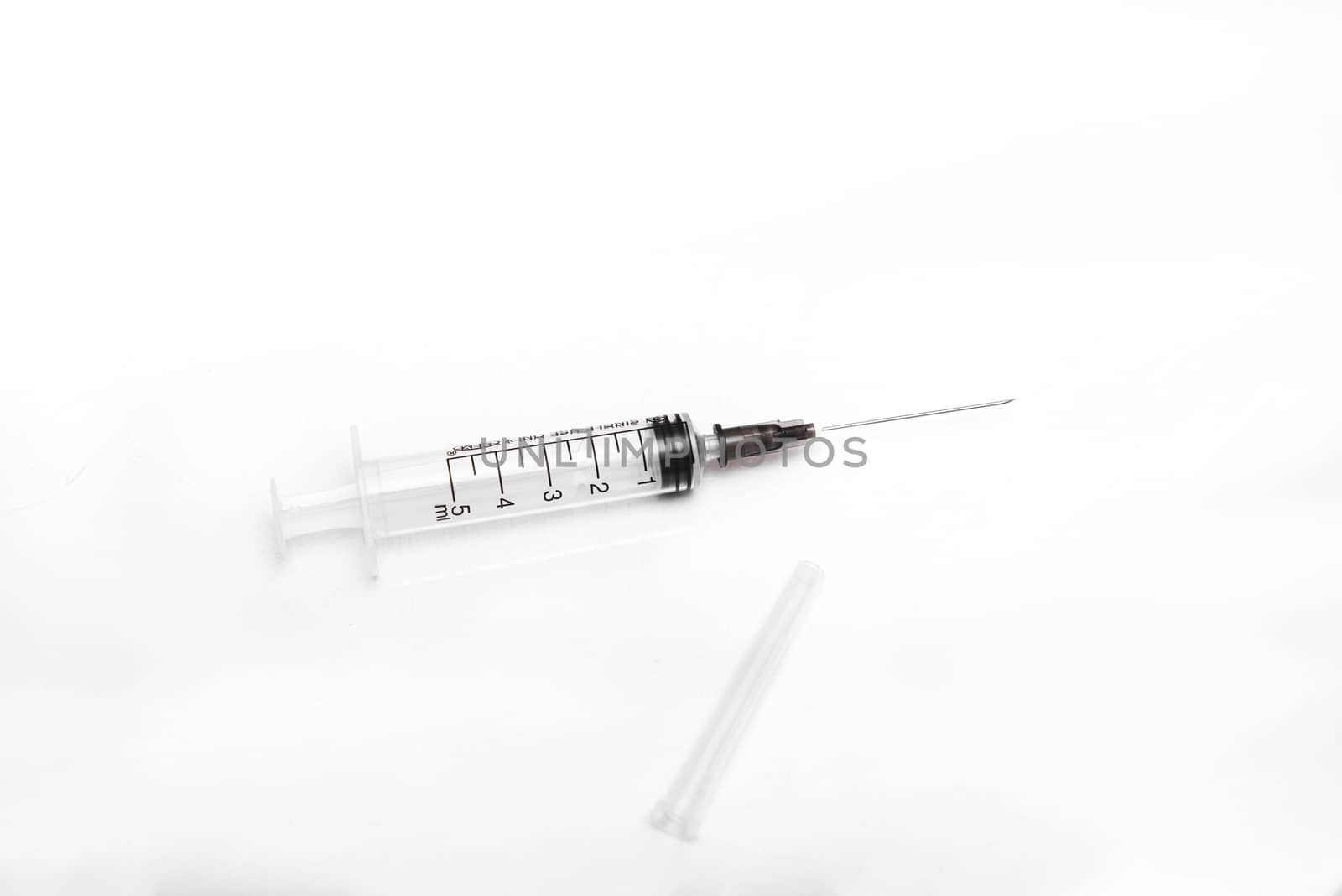medical syringe with needle on an isolated white background with copy space by marynkin