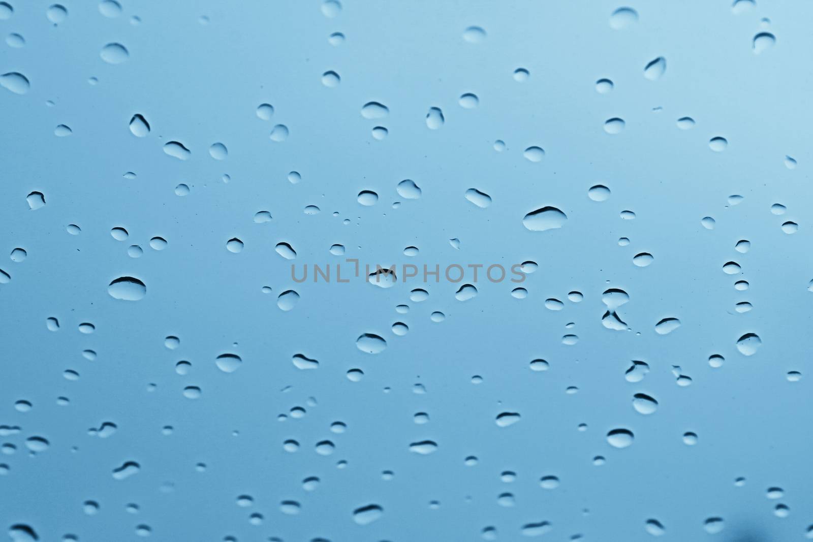 water rain drop on soft blue nature glass for abstract fresh background