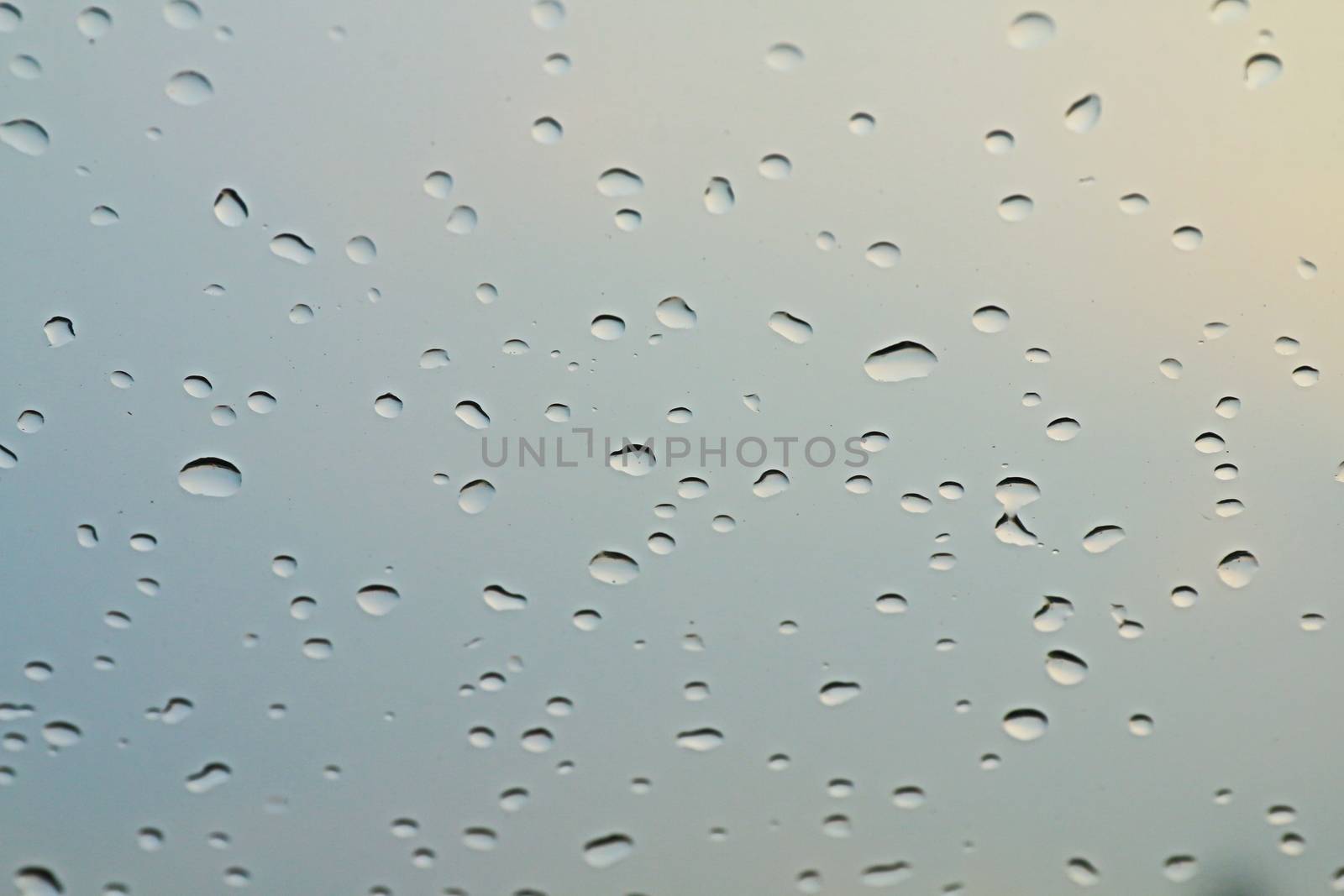 water rain drop on soft blue nature glass for abstract fresh background