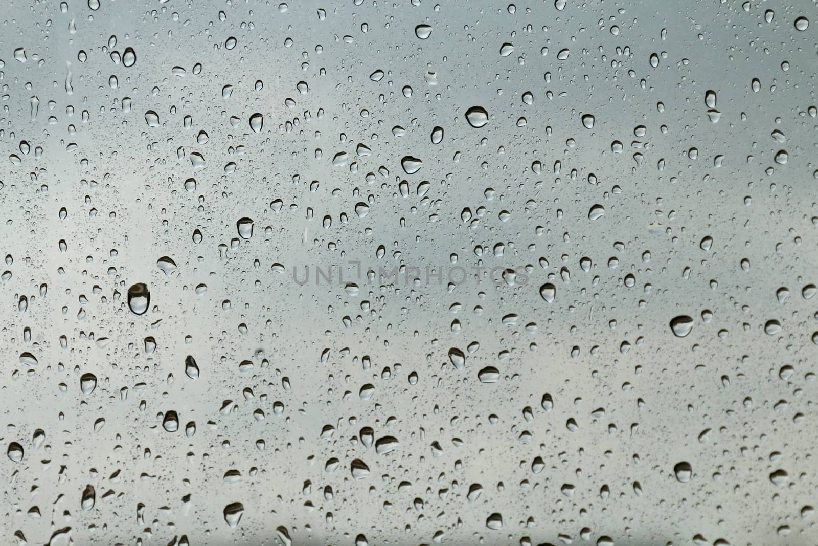 Water drop fresh condensation on window glass texture, rainy season wet background cooling feels and cold, raindrops texture wet transparent bubble