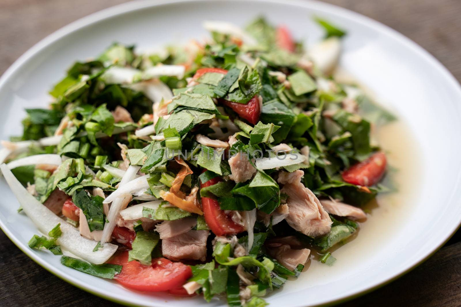 Spicy tuna salad with green tea leaves.