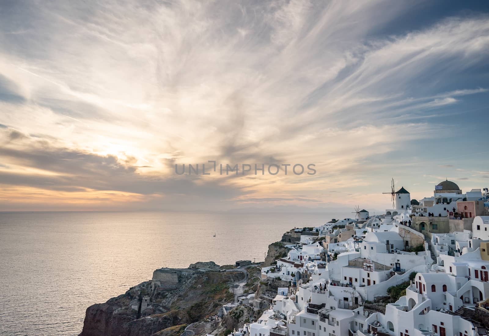 Beautiful sunset. Santorini, Oia. Greece. Sunset sky with the sun and clouds