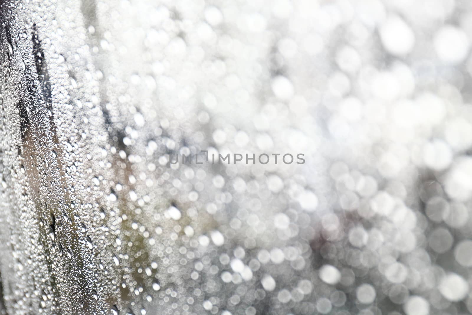 Water drop fresh condensation on window glass texture, rainy season wet background cooling feels and cold, raindrops texture wet transparent bubble